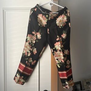 Black pants with printed flowers, silk material. Used twice